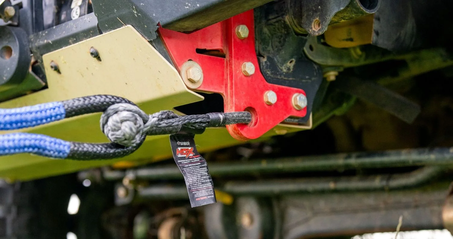 Close-up of a Saber HDX Technora-bound soft shackle connected to a rated recovery point on the underside of a 4WD